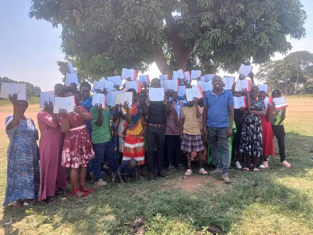 Believers with their Bible and certificate in Uganda