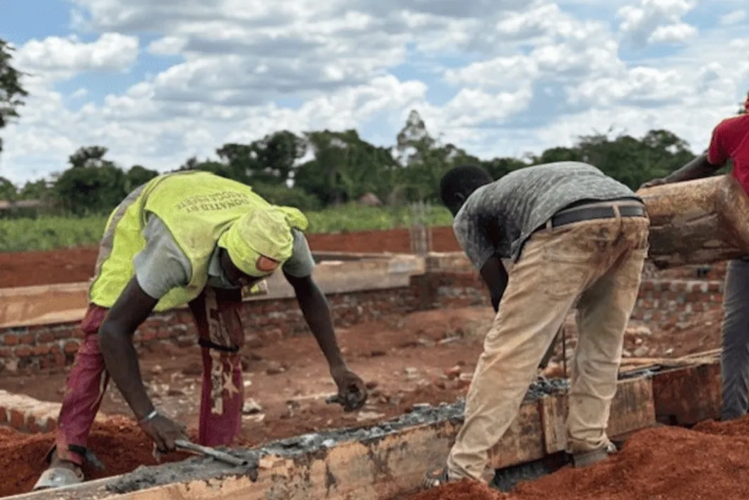 Workers laying the foundation of the new building
